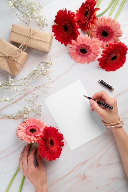 Top view of flowers with blank card and gifts