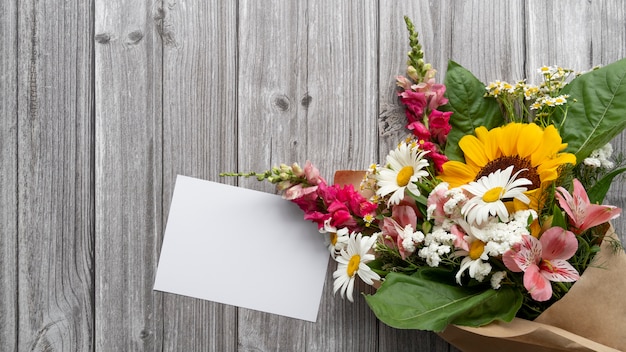 Top view of flowers with blank card