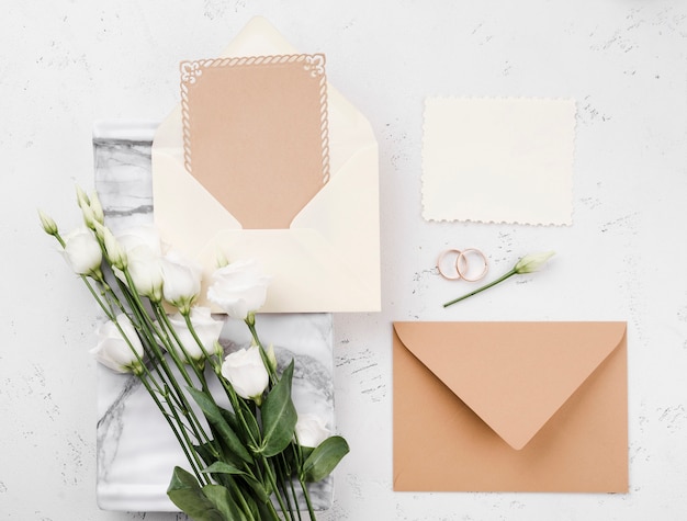 Top view flowers with wedding invitation cards