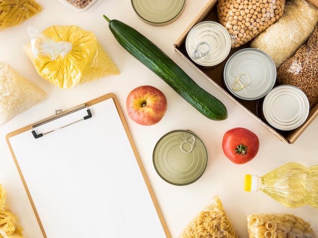 Top view of food for donation and notepad