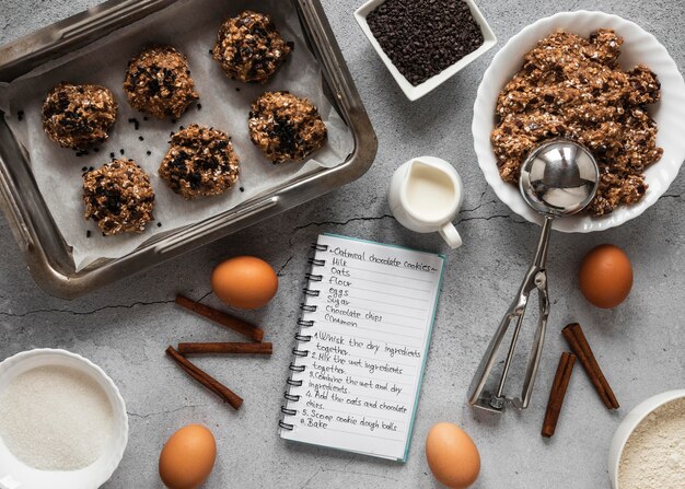 Top view of food ingredients with notebook and dessert mix