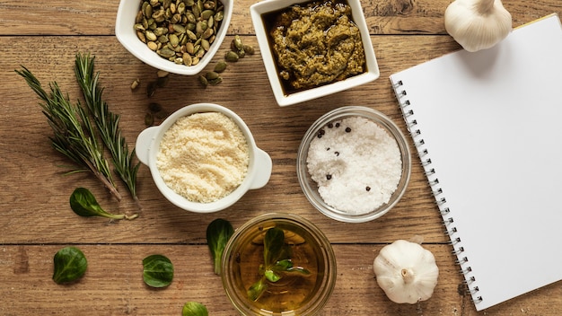 Top view of food ingredients with notebook and herbs