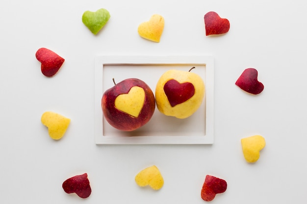 Top view of frame with apples and fruit heart shapes