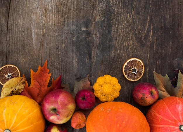 Free photo top view frame with autumn fruits on wooden background