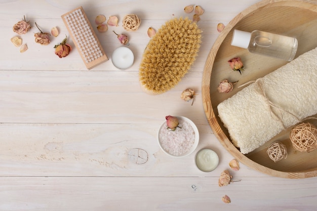 Top view frame with bath items on wooden background