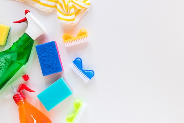 Top view frame with cleaning items and white background