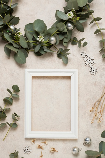 Top view frame with leaves branches beside