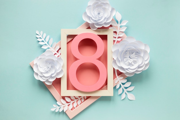 Top view of frame with paper flowers and date for women's day