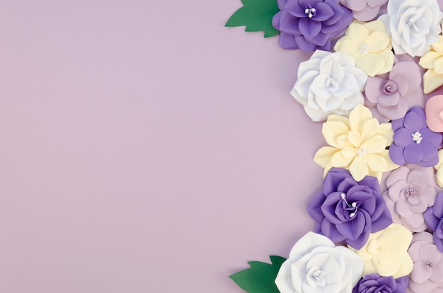 Free Photo top view frame with paper flowers on purple background