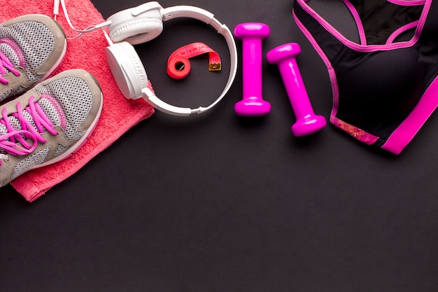 Free photo top view frame with pink items and white headphones