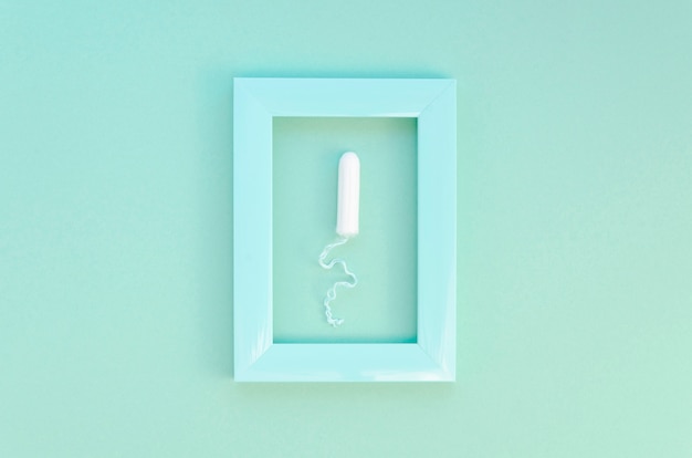 Top view framed tampon on blue background