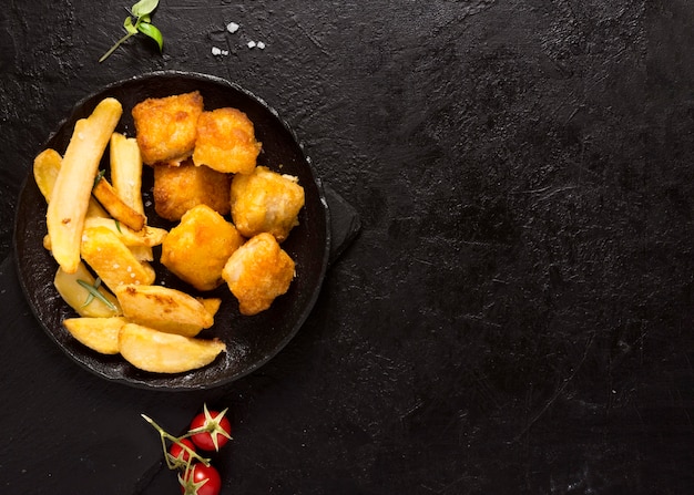 Top view of french fries in bowl with copy space and salt