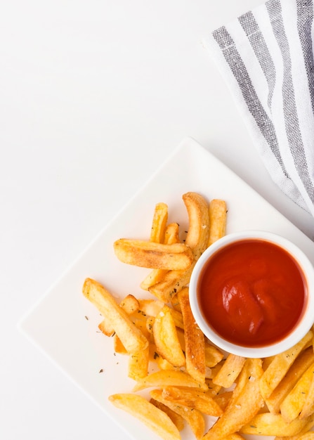 Free Photo top view of french fries on plate with ketchup and copy space