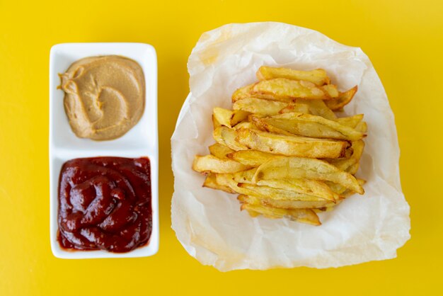 Top view french fries with yellow background