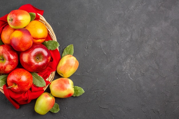 Top view fresh apples with peaches inside basket on dark table fruit ripe fresh