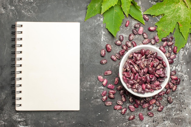 Free photo top view fresh beans with green leaves on the dark surface