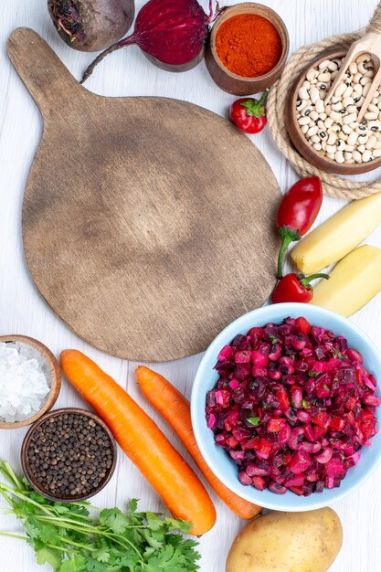 Free Photo top view of fresh beet salad with sliced vegetables along with raw beans carrots potatoes on white desk, food meal vegetable salad