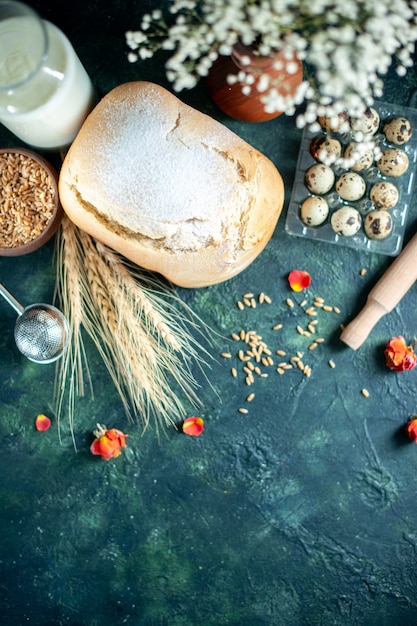 Free photo top view fresh bread with milk and eggs on dark-blue surface