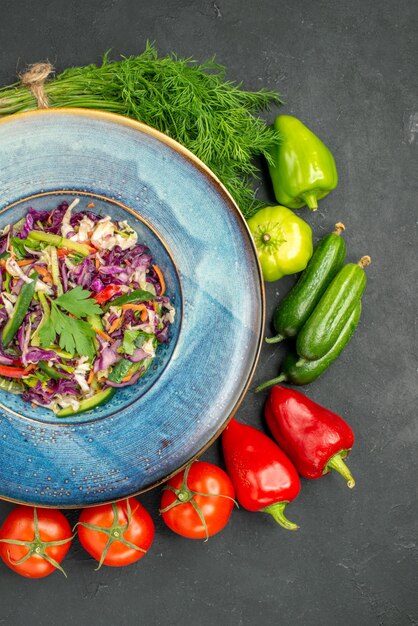 Top view fresh cabbage salad with greens and vegetables on dark background