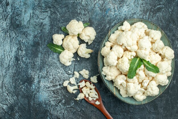 Top view fresh cauliflower inside plate on a light-grey table