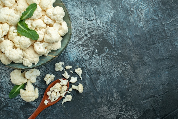 Top view fresh cauliflower inside plate on light-grey table