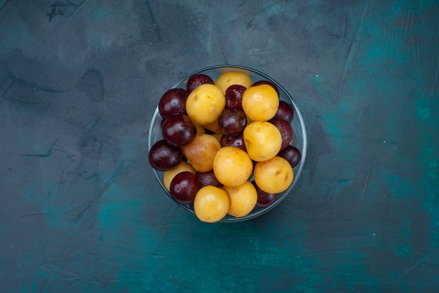 Free Photo top view fresh cherries mellow fruits inside glass on the dark-blue background fresh cherry sweet cherry ripe