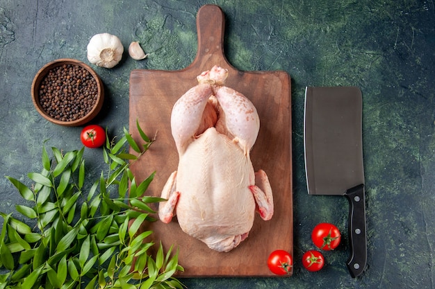 Free photo top view fresh chicken with green leaves on dark-blue surface