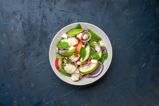 Top view fresh chooped salad in bowl dark blue background