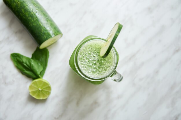 Top view of a fresh cucumber smoothie jar mug