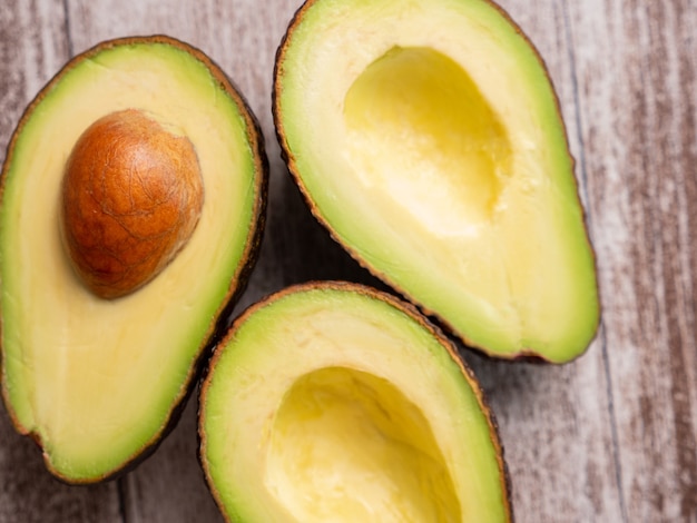 Top view of fresh cutted avocado on wooden board