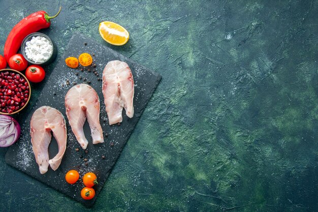 Top view fresh fish slices on dark background dish salad seafood ocean meat sea pepper food water meal