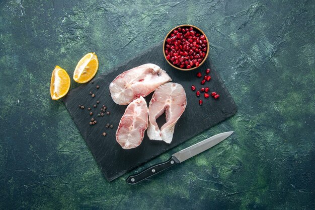 Top view fresh fish slices on dark background meat seafood sea meal food ocean pepper water raw