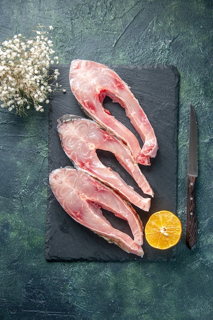 top view fresh fish slices on dark background