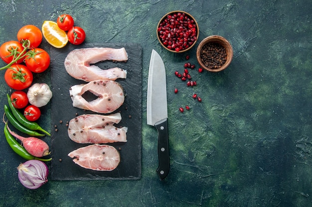 Top view fresh fish slices with red tomatoes on dark background ocean meat sea meal water food pepper dish seafood