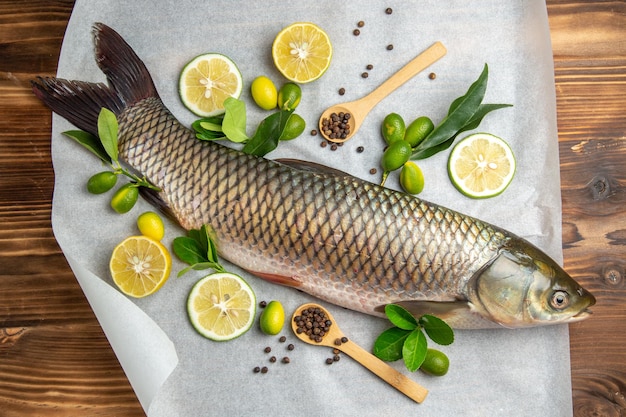 Top view fresh fish with lemon slices on a wooden table food seafood dish ocean