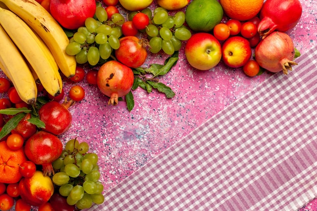 Top view fresh fruit composition colorful fruits on the pink surface