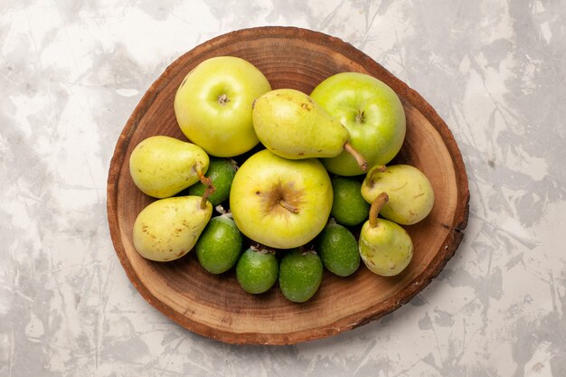 Top view fresh fruits apples feijoa and pears on white space