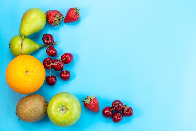 Free Photo a top view fresh fruits colorful composition isolated on blue, fruit color mellow