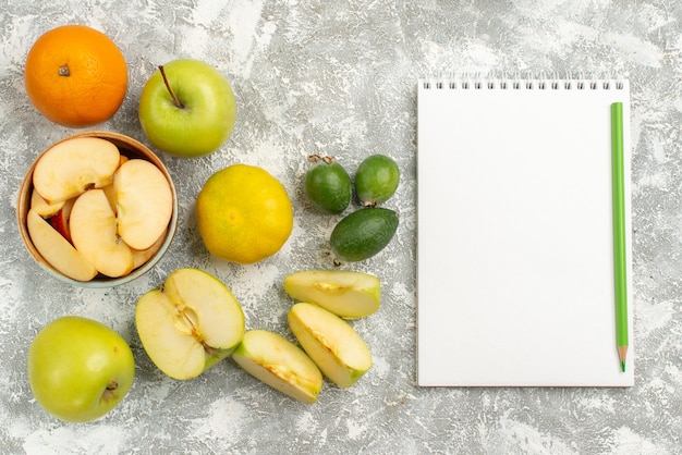 Top view fresh fruits composition apples feijoa and other fruits on white background fresh mellow fruit ripe color vitamine