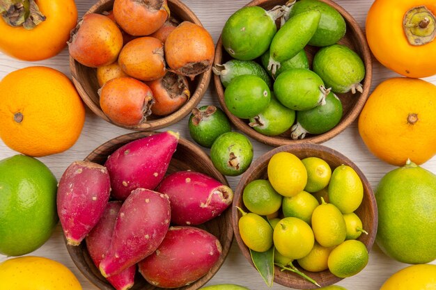 Top view fresh fruits composition different fruits on a white background