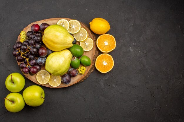 Top view fresh fruits composition mellow and ripe fruits on dark floor fruit mellow fresh ripe vitamine