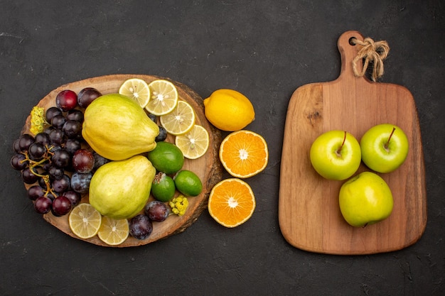 Top view fresh fruits composition mellow and ripe fruits on the dark surface fruit mellow fresh ripe vitamine