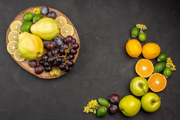 Top view fresh fruits composition ripe and mellow fruits on dark desk fruit fresh vitamine mellow ripe