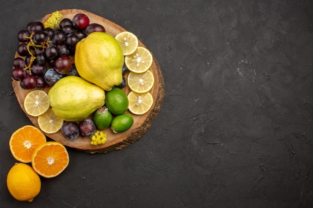 Top view fresh fruits composition sliced and ripe on dark surface fruit ripe mellow health fresh