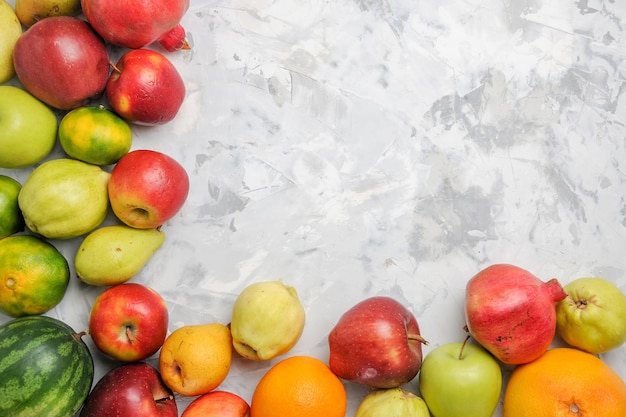 Top view fresh fruits composition on a white background