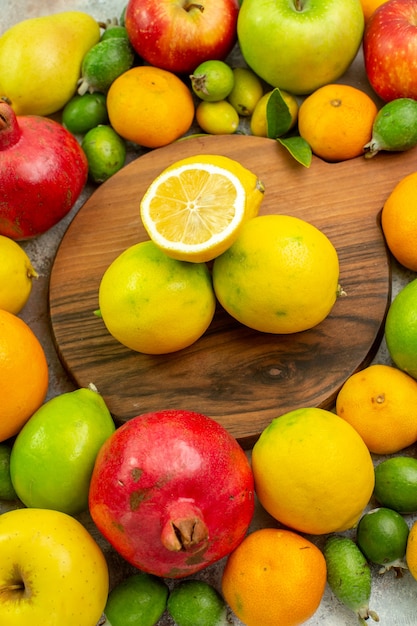 Top view fresh fruits different ripe and mellow fruits on white background berry color diet photo tasty health