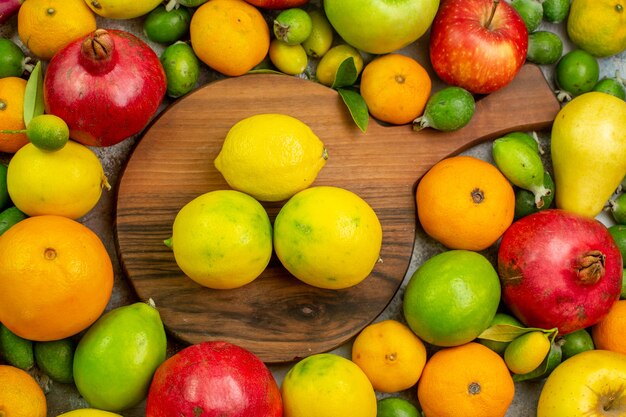 Top view fresh fruits different ripe and mellow fruits on white background berry color health diet photo tasty