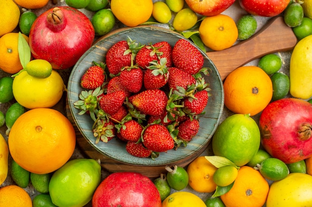 Top view fresh fruits different ripe and mellow on a white background