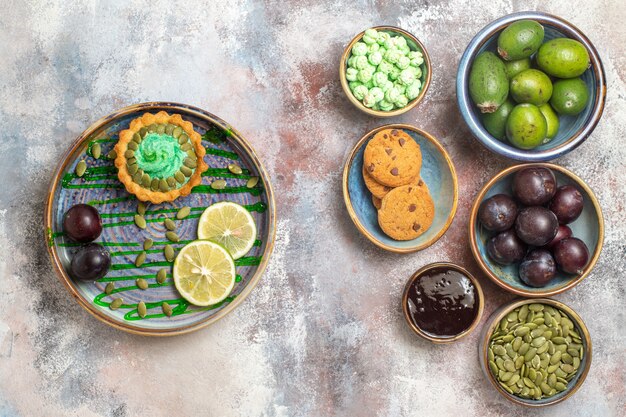 Top view fresh fruits with biscuits and cake