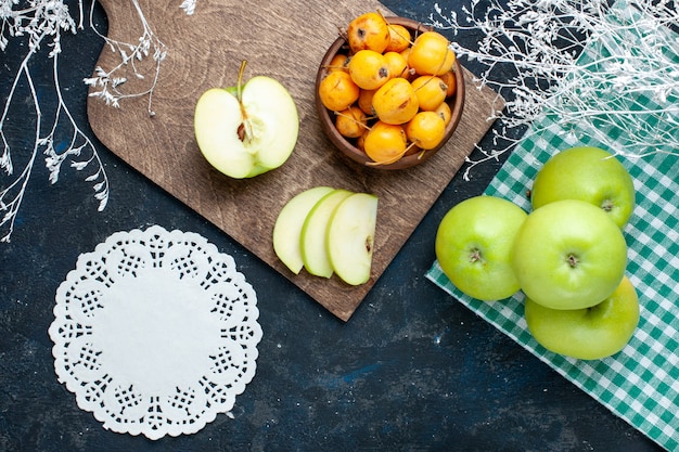 Top view of fresh green apples with sweet mellow cherries on dark desk, fruit fresh mellow food vitamine